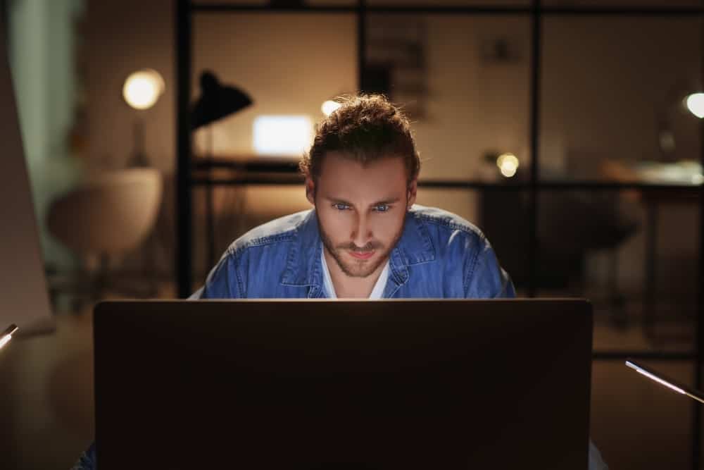 людина працює вдома пізно ввечері