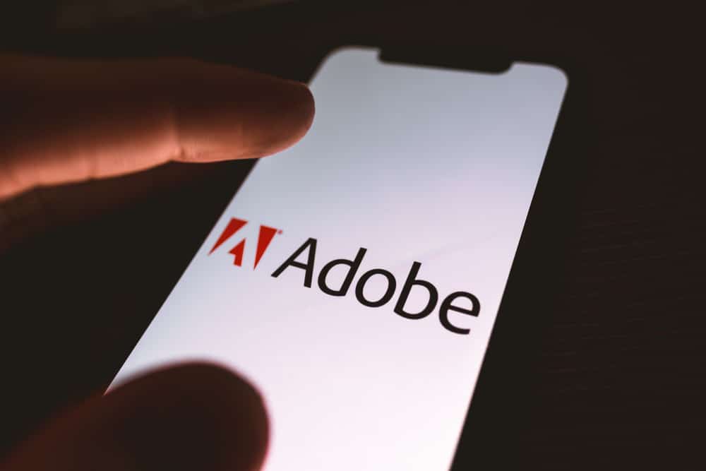 Логотип компанії Adobe на екрані смартфона